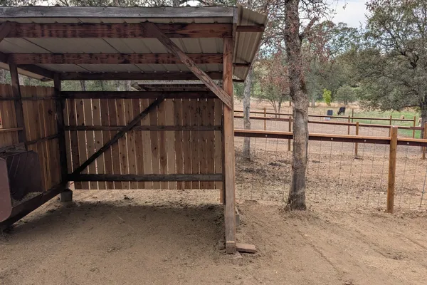 Covered horse shelter with turnout fencing at Sparrow Valley Ranch